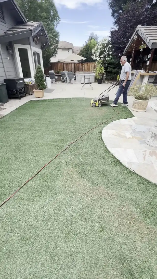 Power brooming a residential artificial turf lawn